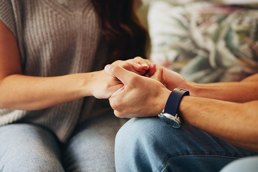 Photo of a young couple holding hands